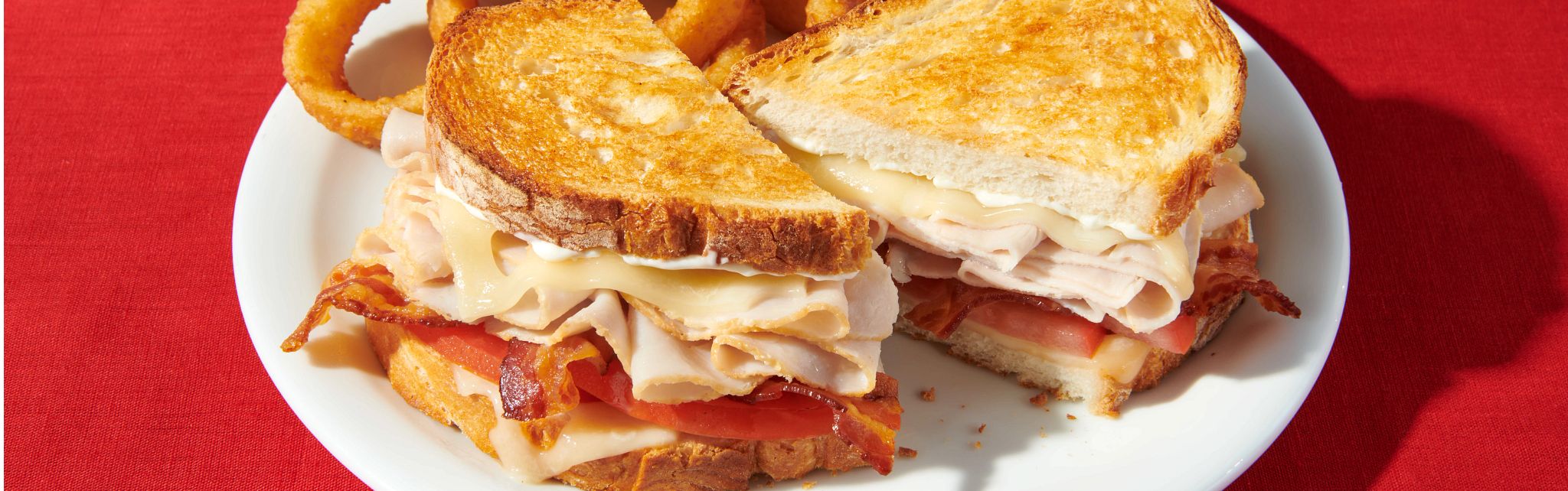 Denny's super bird sandwich with onion rings