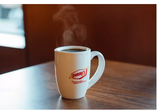 A coffee mug with the Denny's logo and the phrase "It's Diner Time" on the front