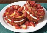 Denny's Strawberry Stuffed French Toast with cream cheese filling, strawberries, and powdered sugar